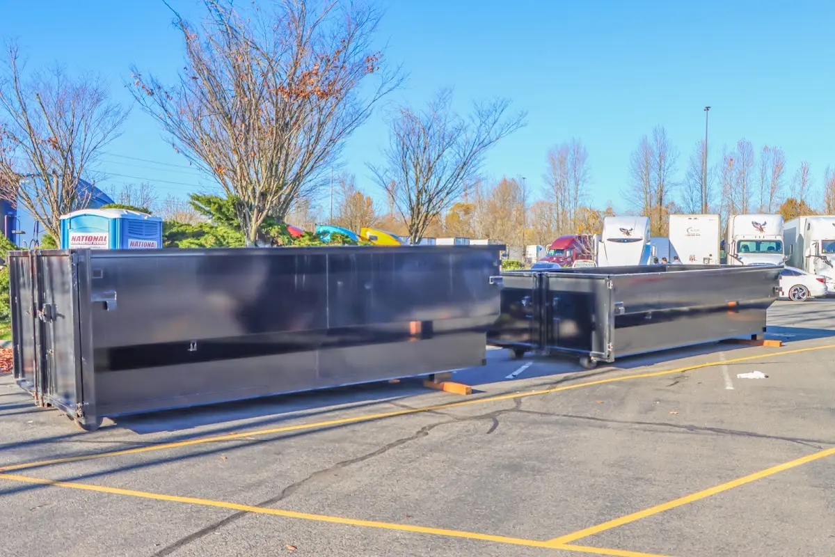 Professional dumpster rental service with roll-off container on residential driveway in Newburyport